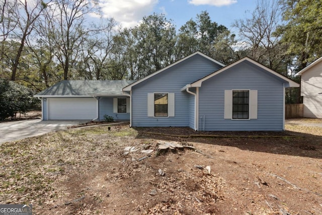 ranch-style home featuring driveway and a garage