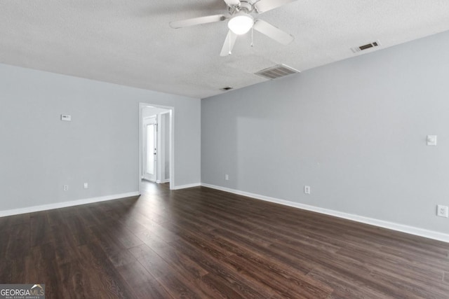 spare room featuring baseboards, a textured ceiling, dark wood-style floors, visible vents, and a ceiling fan