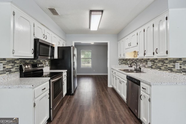 kitchen with visible vents, stainless steel appliances, white cabinetry, a sink, and dark wood-style floors