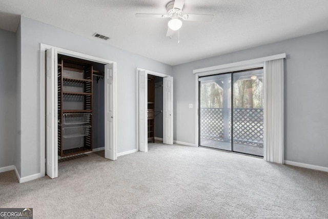 unfurnished bedroom featuring baseboards, visible vents, carpet flooring, and access to outside