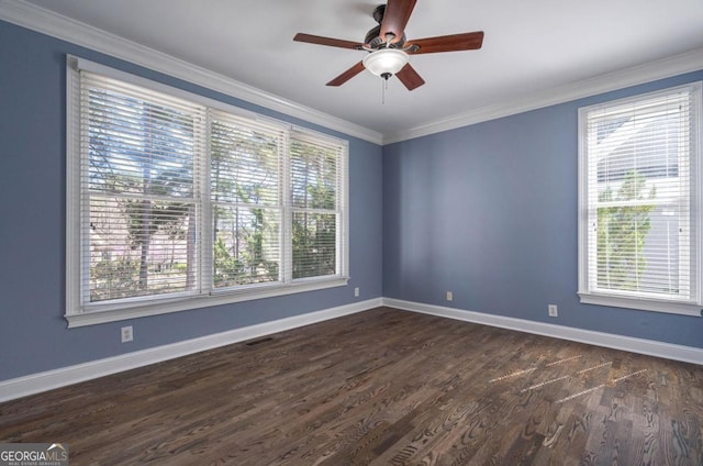 unfurnished room with crown molding, dark wood-type flooring, baseboards, visible vents, and a ceiling fan