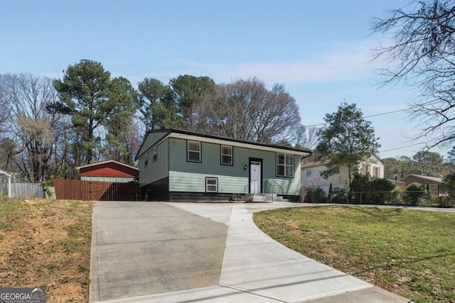 view of front of property with a front yard, driveway, fence, and entry steps