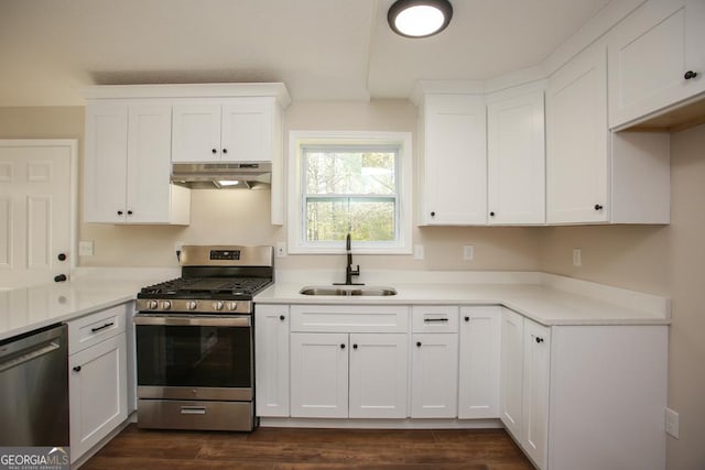 759 Oak Grove Rd, Carrollton, GA 30117 - kitchen with a sink, stainless steel appliances, dark wood finished floors, under cabinet range hood, and white cabinetry