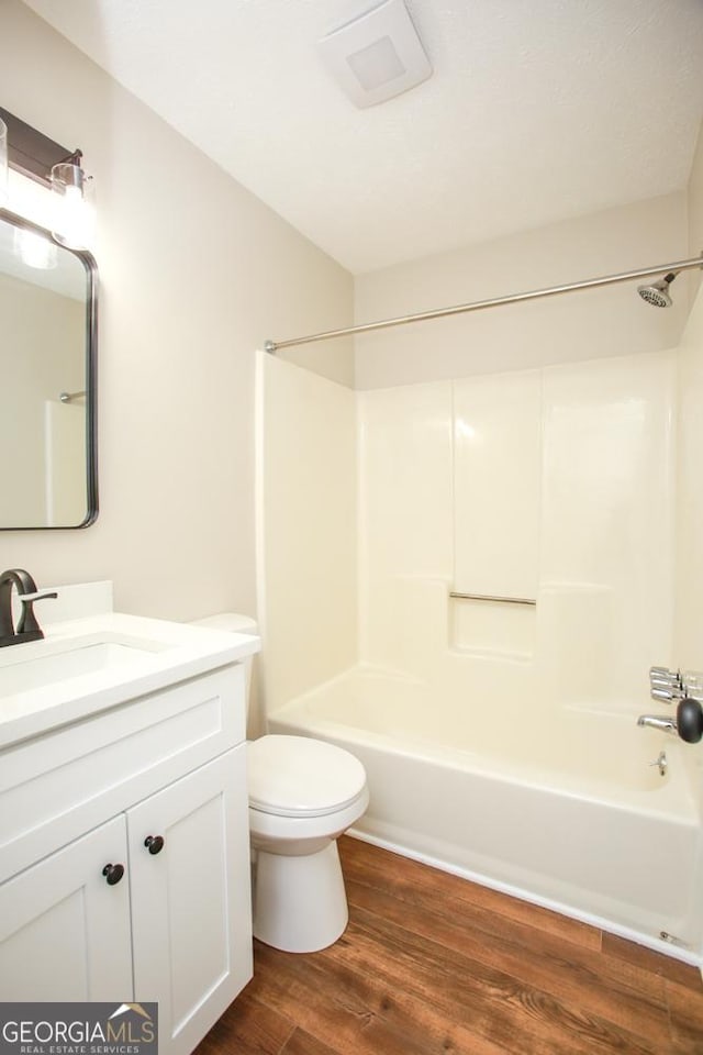 759 Oak Grove Rd, Carrollton, GA 30117 - full bathroom with toilet, vanity, shower / washtub combination, and wood finished floors