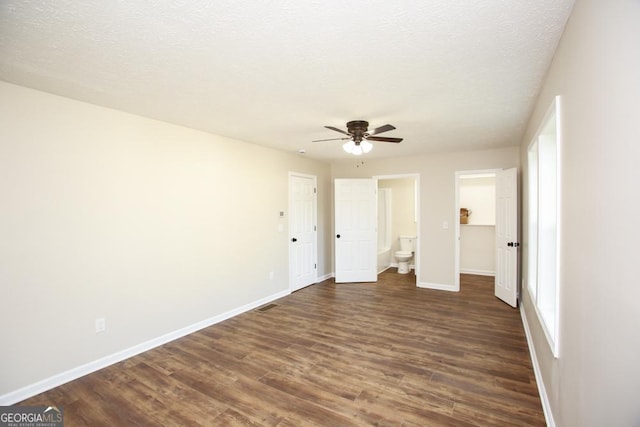 759 Oak Grove Rd, Carrollton, GA 30117 - unfurnished bedroom with connected bathroom, baseboards, a closet, and dark wood finished floors