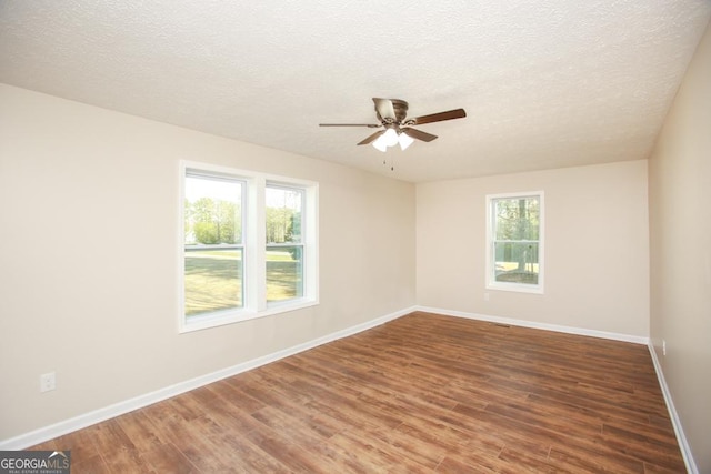 759 Oak Grove Rd, Carrollton, GA 30117 - spare room featuring ceiling fan, a textured ceiling, baseboards, and wood finished floors