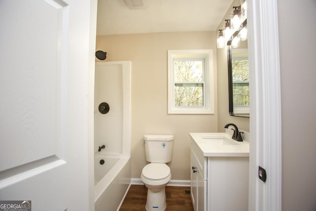 759 Oak Grove Rd, Carrollton, GA 30117 - bathroom with toilet, wood finished floors, baseboards, vanity, and shower / bathing tub combination