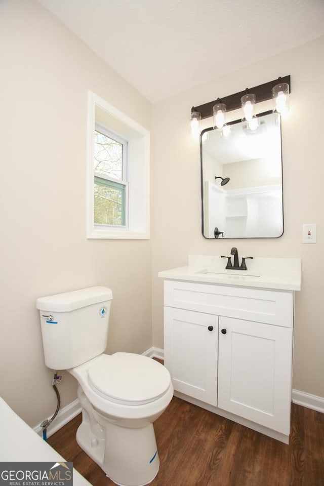 759 Oak Grove Rd, Carrollton, GA 30117 - bathroom featuring toilet, wood finished floors, and baseboards