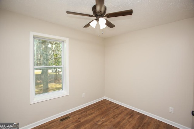 759 Oak Grove Rd, Carrollton, GA 30117 - empty room with baseboards, ceiling fan, visible vents, and dark wood-style floors