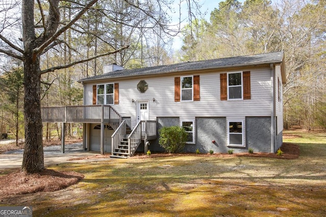 759 Oak Grove Rd, Carrollton, GA 30117 - bi-level home featuring a wooden deck, a chimney, a garage, and a carport