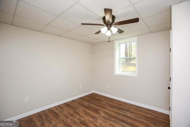 759 Oak Grove Rd, Carrollton, GA 30117 - spare room with a drop ceiling, baseboards, a ceiling fan, and dark wood-style floors
