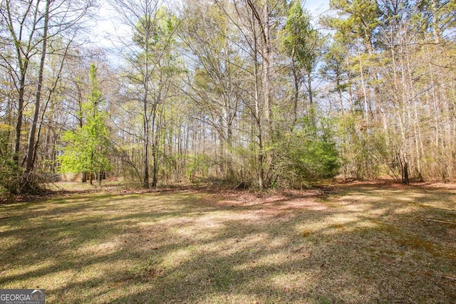 759 Oak Grove Rd, Carrollton, GA 30117 - wooden deck with a wooded view and a lawn