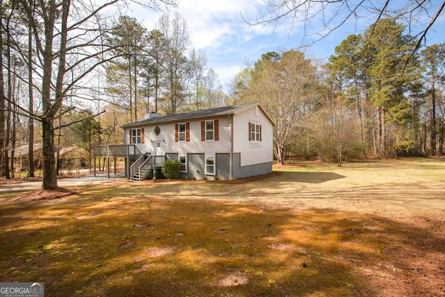 759 Oak Grove Rd, Carrollton, GA 30117 - view of front of home featuring a front lawn, a chimney, stairway, and a deck