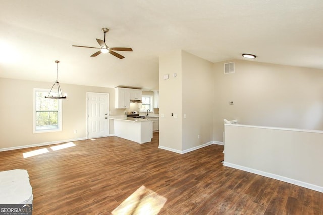 759 Oak Grove Rd, Carrollton, GA 30117 - unfurnished living room featuring baseboards, ceiling fan with notable chandelier, dark wood-style floors, and vaulted ceiling