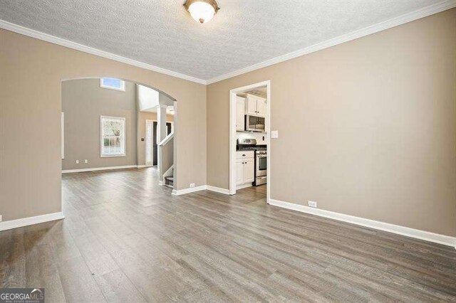 802 Eagle Glen Xing, Woodstock, GA 30189 - spare room featuring arched walkways, a textured ceiling, dark wood-style floors, stairway, and ornamental molding