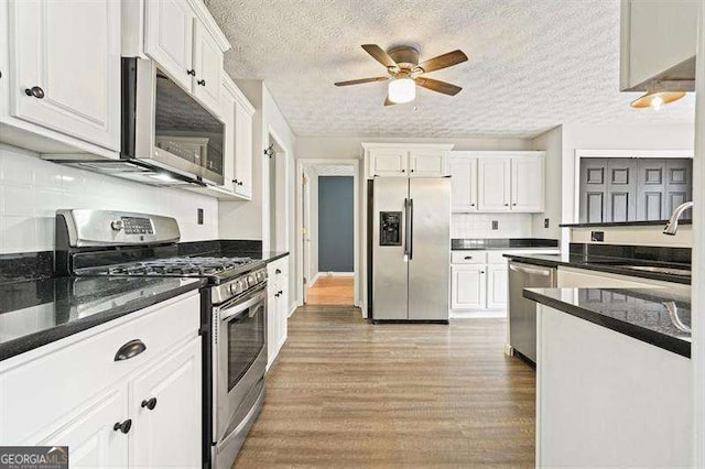 802 Eagle Glen Xing, Woodstock, GA 30189 - kitchen with stainless steel appliances, ceiling fan, wood finished floors, white cabinetry, and a textured ceiling