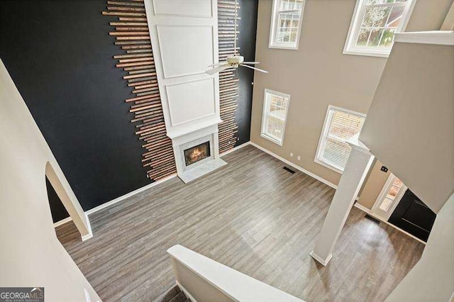 802 Eagle Glen Xing, Woodstock, GA 30189 - entryway with a fireplace with flush hearth, wood finished floors, plenty of natural light, a ceiling fan, and a high ceiling