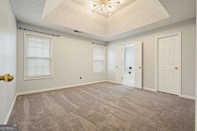 802 Eagle Glen Xing, Woodstock, GA 30189 - carpeted spare room with plenty of natural light, a tray ceiling, and a textured ceiling