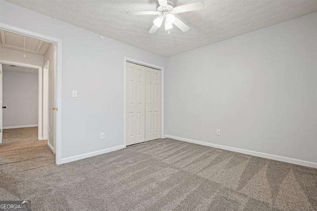 802 Eagle Glen Xing, Woodstock, GA 30189 - unfurnished bedroom featuring attic access, a textured ceiling, carpet, a closet, and a ceiling fan