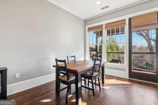 dining room featuring dark wood-style floors and baseboards
