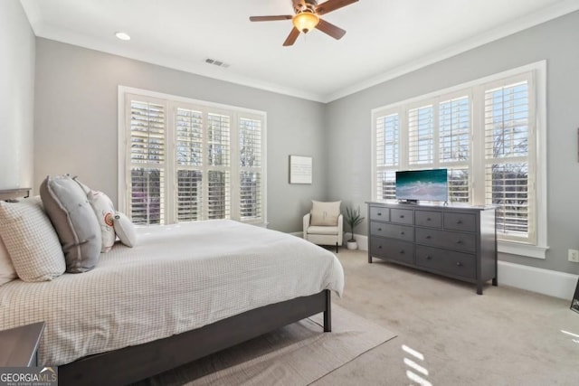bedroom featuring crown molding, multiple windows, light colored carpet, ceiling fan, and baseboards