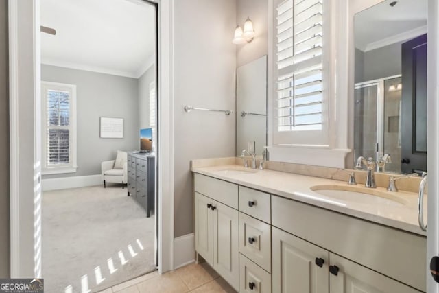 bathroom with ornamental molding, double vanity, a stall shower, baseboards, and tile patterned flooring