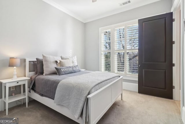 bedroom featuring carpet flooring and crown molding