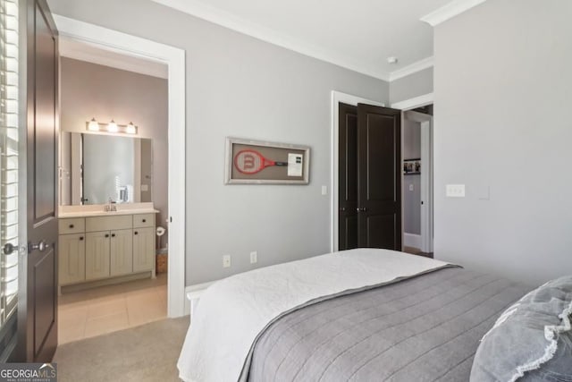 bedroom with ornamental molding, a sink, light tile patterned floors, ensuite bathroom, and light colored carpet