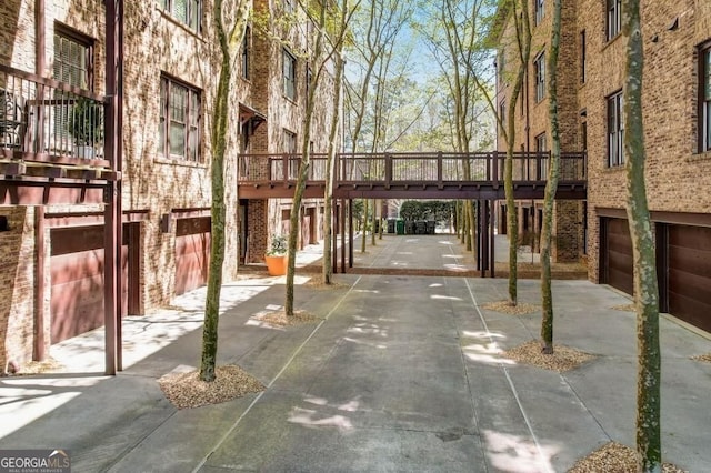 misc room with a towering ceiling, plenty of natural light, and concrete floors