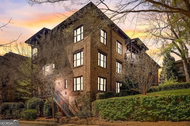 property at dusk with stairs