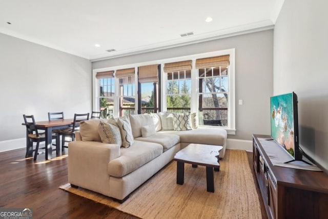 living room with baseboards, wood finished floors, and recessed lighting