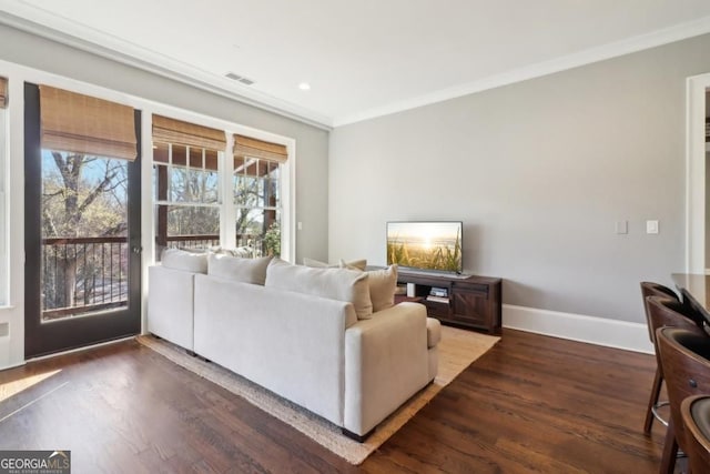 living room with crown molding, wood finished floors, baseboards, and recessed lighting