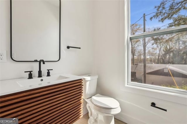 half bath featuring toilet and vanity