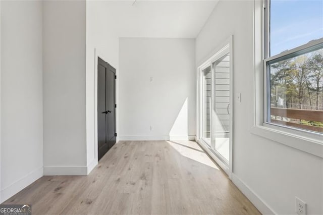 interior space with baseboards and wood finished floors