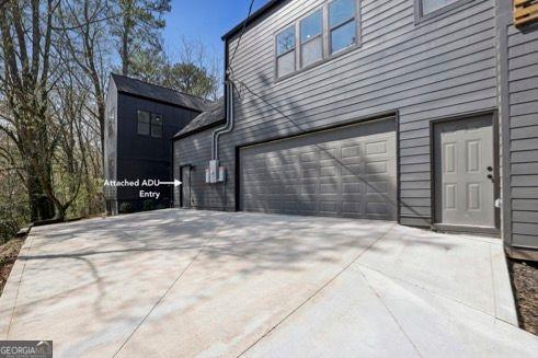 view of home's exterior featuring a garage and concrete driveway