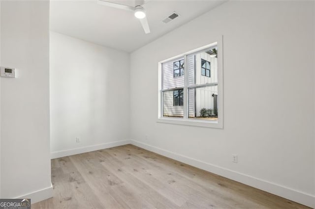 spare room with baseboards, visible vents, ceiling fan, and light wood-type flooring