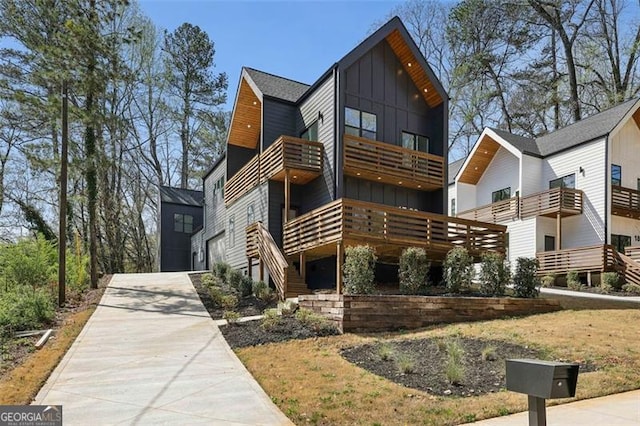 contemporary home featuring driveway, a garage, and board and batten siding
