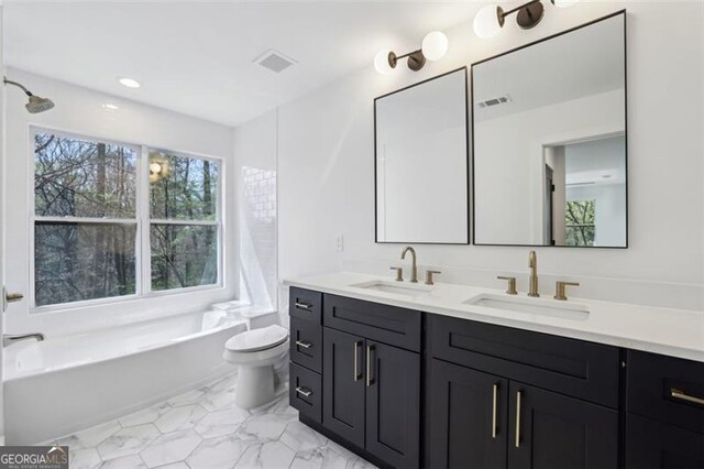 full bath featuring double vanity, visible vents, toilet, and a sink