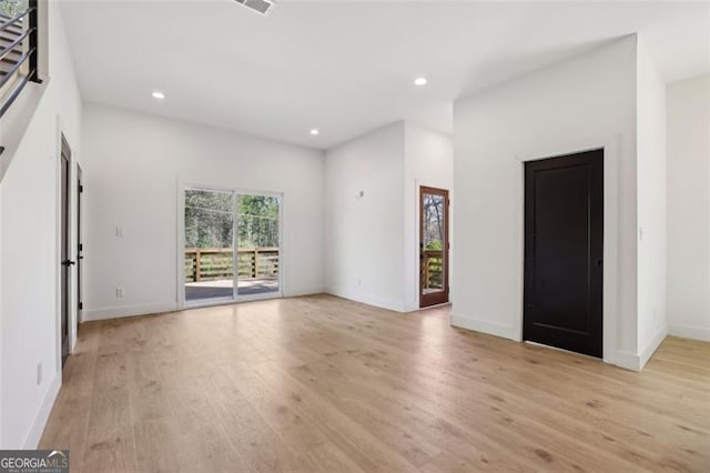 unfurnished living room with light wood finished floors, baseboards, visible vents, and recessed lighting