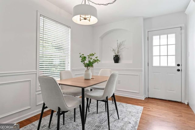 382 Deckner Ave SW, Atlanta, GA 30310 - dining space with a decorative wall, light wood-type flooring, and a notable chandelier