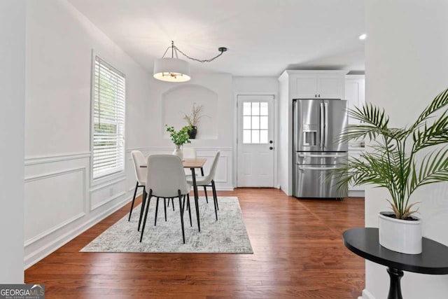 382 Deckner Ave SW, Atlanta, GA 30310 - dining area featuring a decorative wall, a wainscoted wall, and dark wood-type flooring