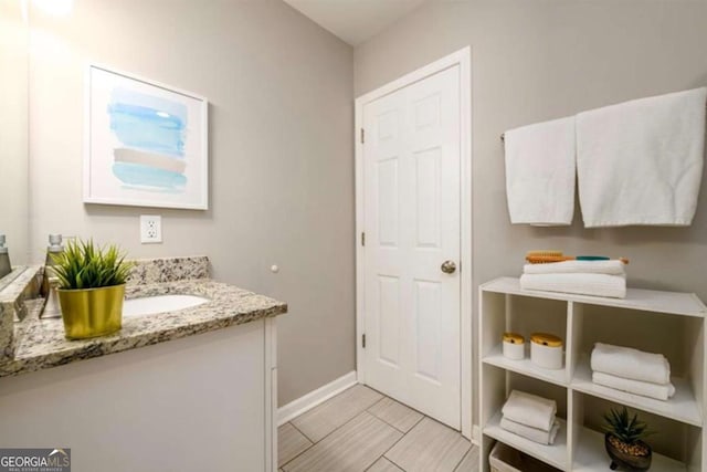 bathroom with baseboards and vanity