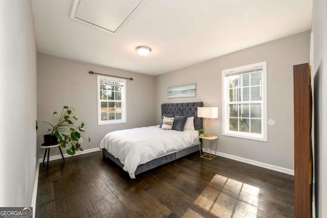 bedroom featuring baseboards and dark wood finished floors