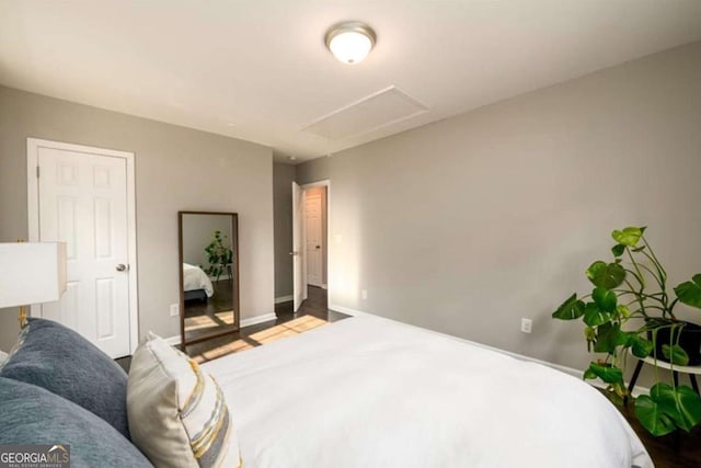 bedroom featuring baseboards and wood finished floors
