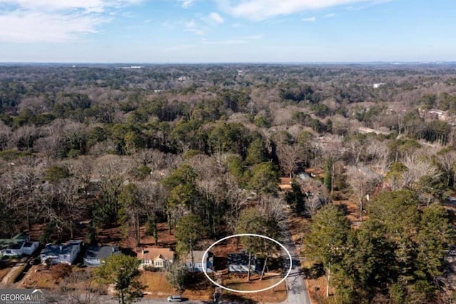 birds eye view of property featuring a wooded view