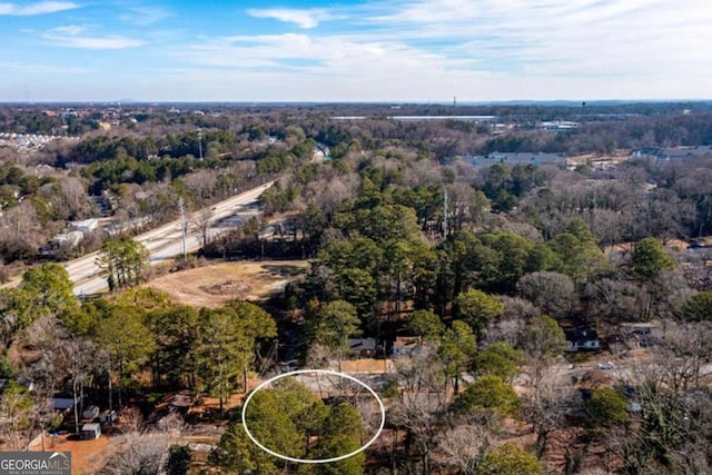 birds eye view of property with a wooded view