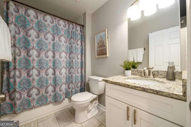 bathroom with toilet, vanity, and shower / bath combo with shower curtain