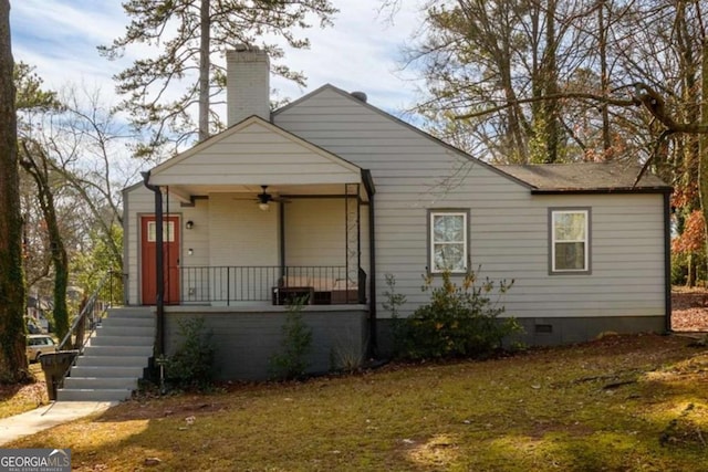 view of front of home featuring covered porch, a ceiling fan, crawl space, and a chimney