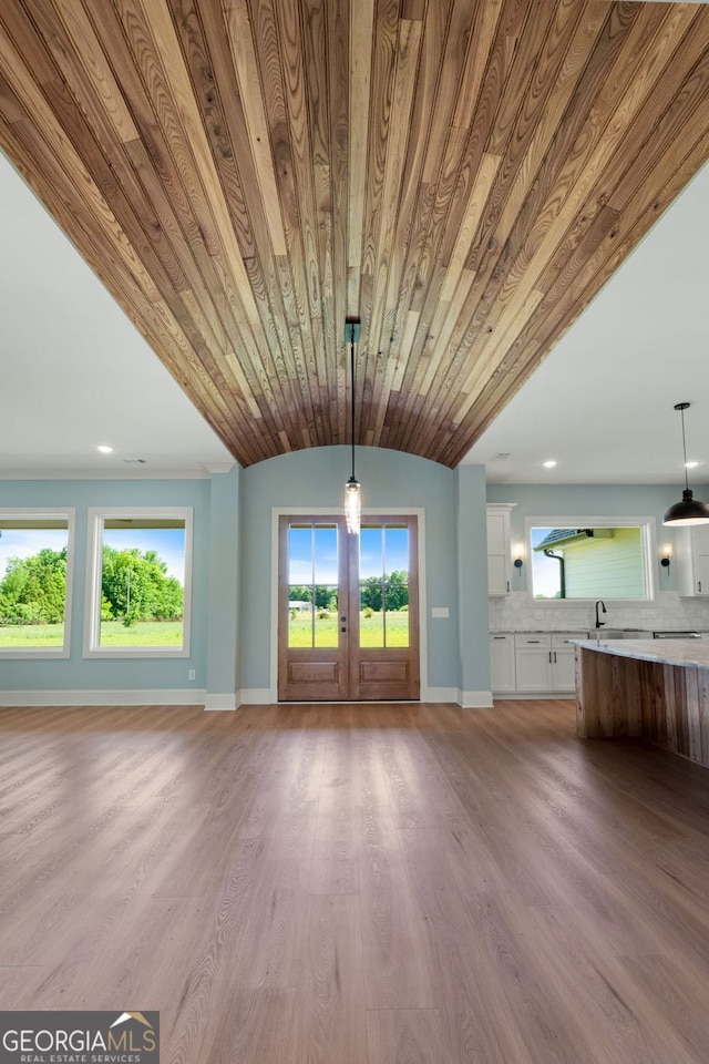 264 Community House Rd, Barnesville, GA 30204 - unfurnished living room with french doors, baseboards, and light wood-style flooring