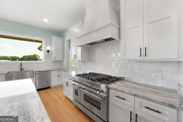 264 Community House Rd, Barnesville, GA 30204 - kitchen featuring stainless steel appliances, custom range hood, white cabinets, a sink, and recessed lighting